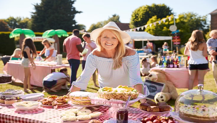 portrait-of-mature-woman-serving-on-cake-stall-at-2021-08-26-16-15-14-utc (1)